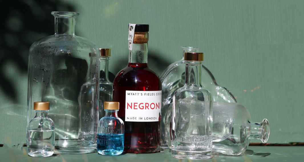 The Myatt's Fields glass range in hard sunlight, a filled Negroni at the centre.